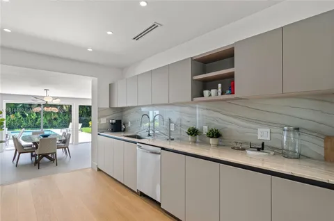 a kitchen with refrigerator a microwave a stove and cabinets