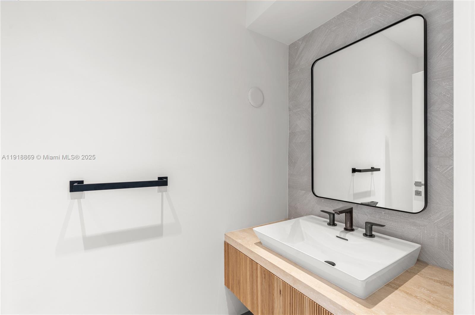 45 Northeast 104th Street Miami Shores, FL 33138 - Photo 22 of 52 a bathroom with a sink a mirror and shower