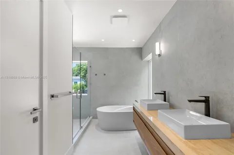 a bathroom with a bathtub and a shower
