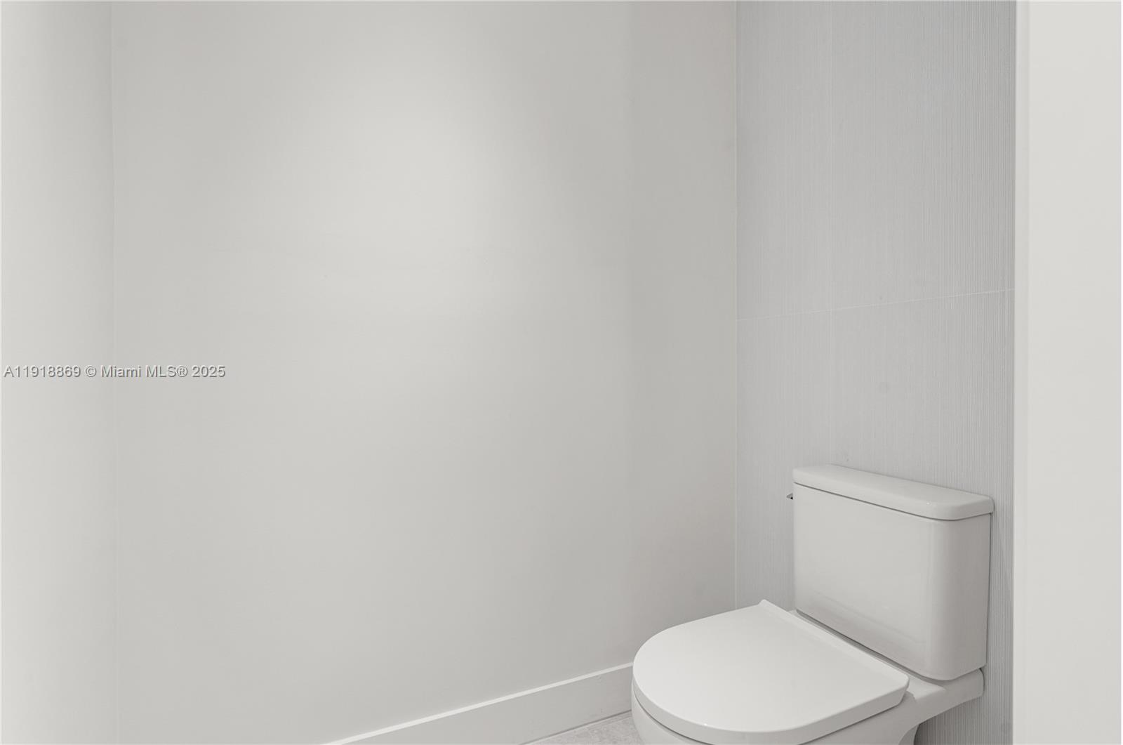 45 Northeast 104th Street Miami Shores, FL 33138 - Photo 30 of 52 a white toilet sitting next to a white wall