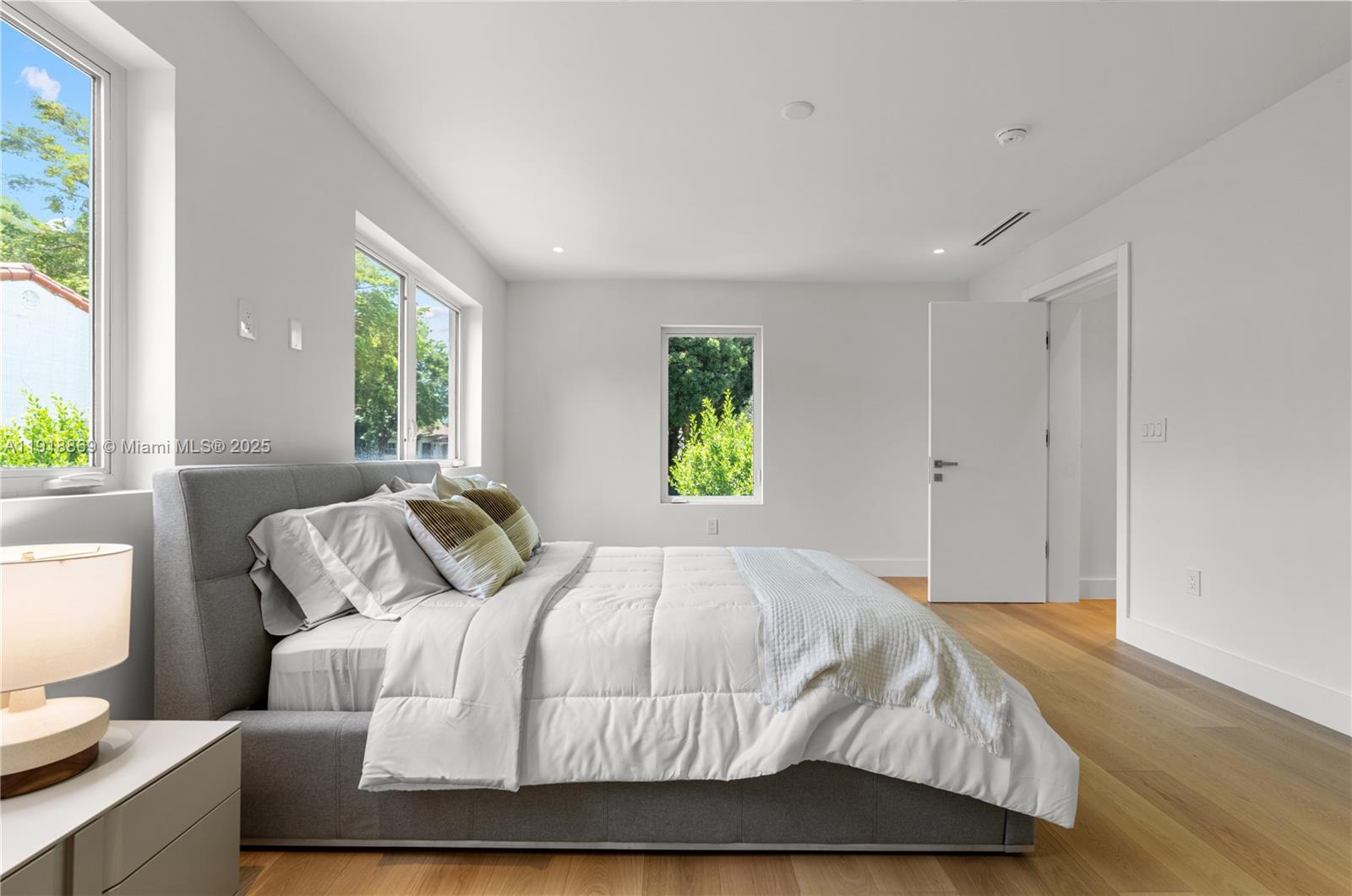 45 Northeast 104th Street Miami Shores, FL 33138 - Photo 31 of 52 a bedroom with a bed and a window