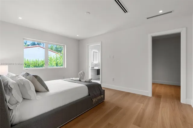 a bedroom with a bed and a table