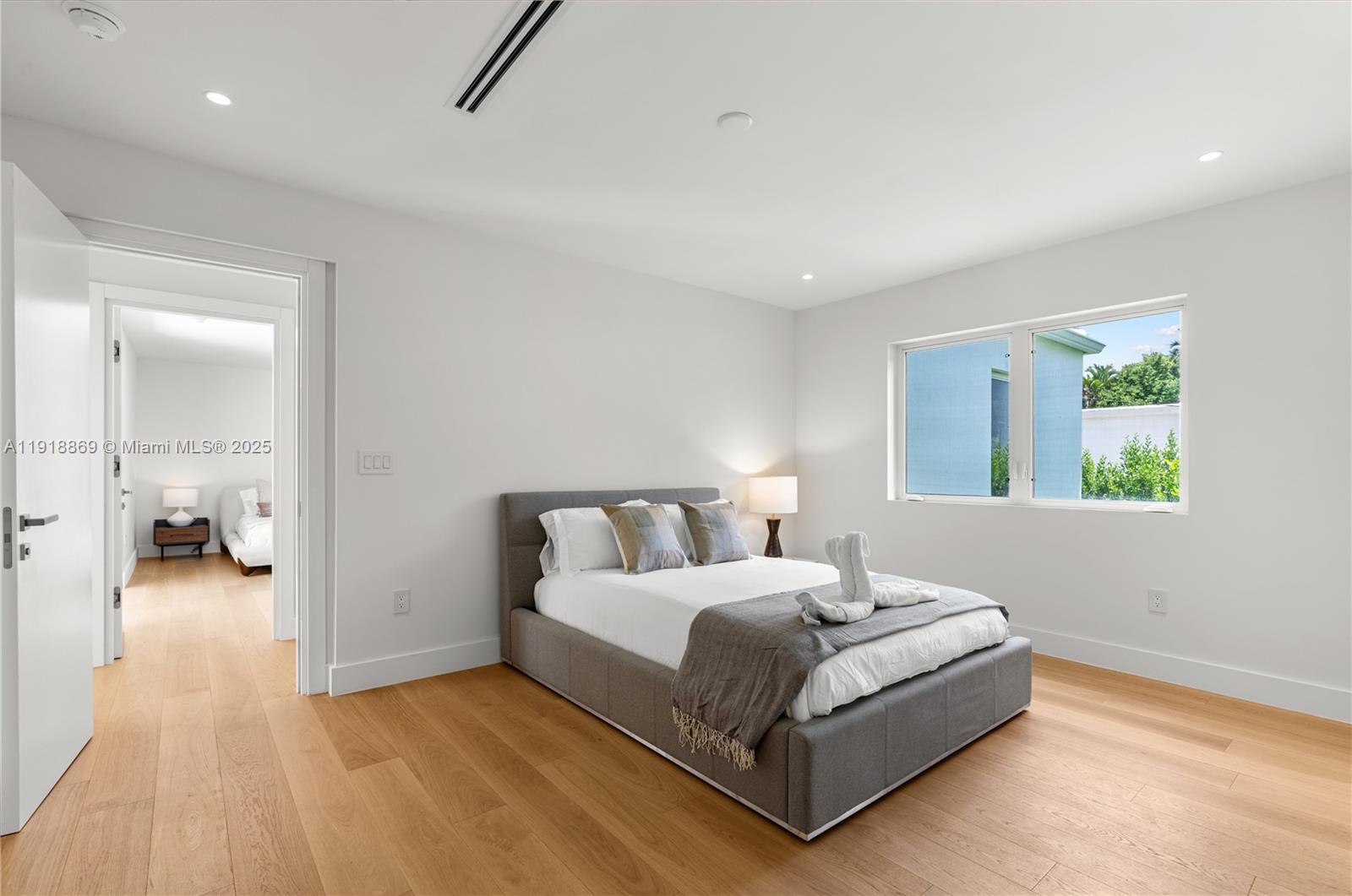 45 Northeast 104th Street Miami Shores, FL 33138 - Photo 37 of 52 a bedroom with a bed and a table