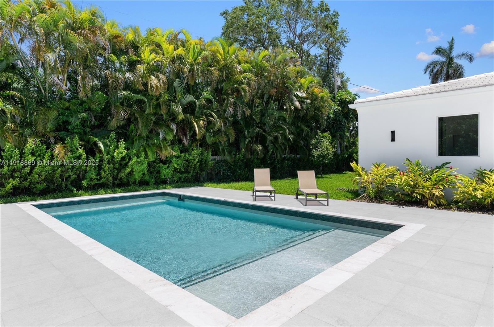 45 Northeast 104th Street Miami Shores, FL 33138 - Photo 45 of 52 a view of a swimming pool with a yard
