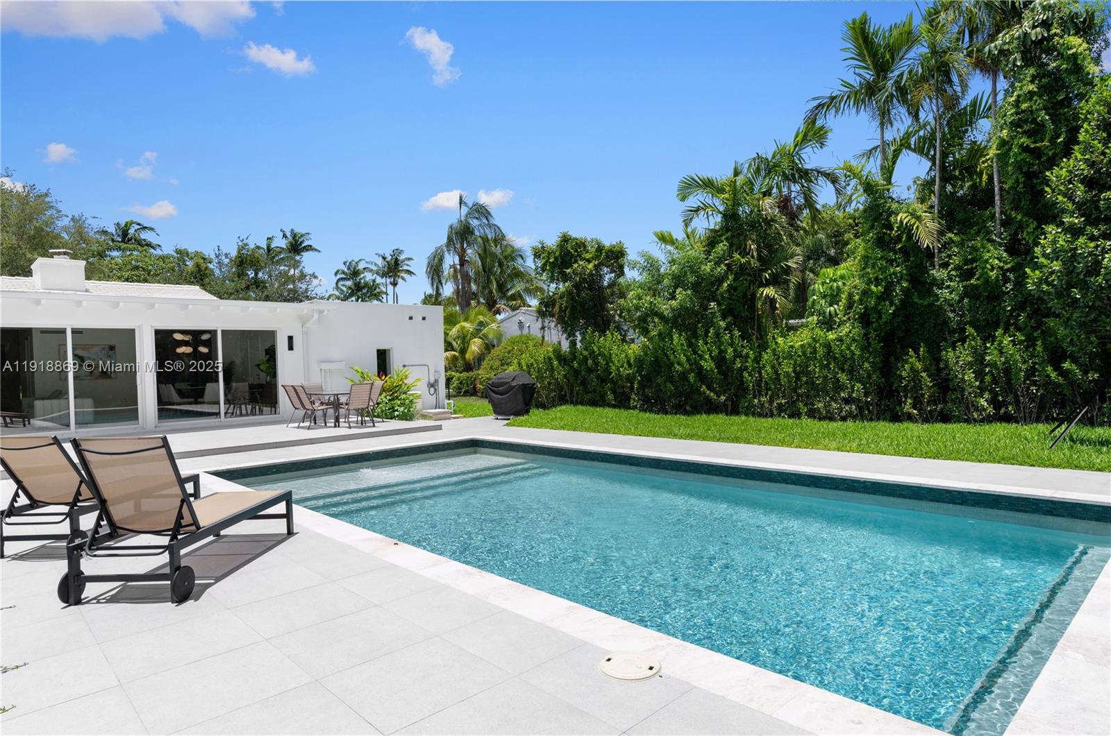 45 Northeast 104th Street Miami Shores, FL 33138 - Photo 48 of 52 a swimming pool with outdoor seating and yard
