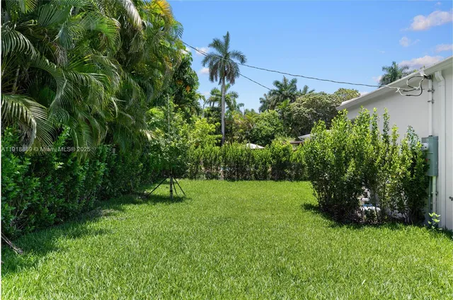 an aerial view of a house with a yard and a fountain