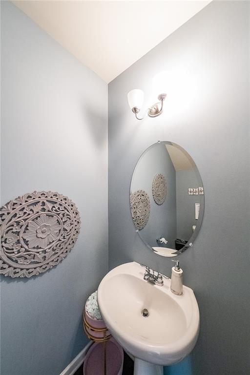 8097 White Oak Loop Lithonia, GA 30038 - Photo 16 of 25 a bathroom with a sink a mirror and toilet