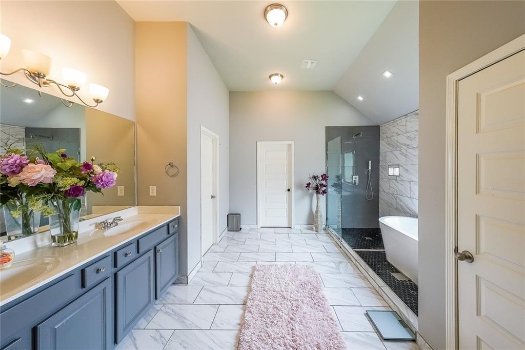 8097 White Oak Loop Lithonia, GA 30038 - Photo 18 of 25 a bathroom with a sink mirror and a shower