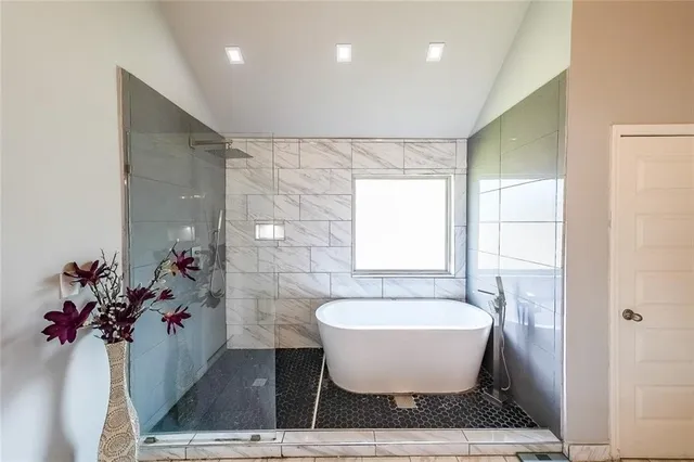 a bathroom with a toilet tub and shower