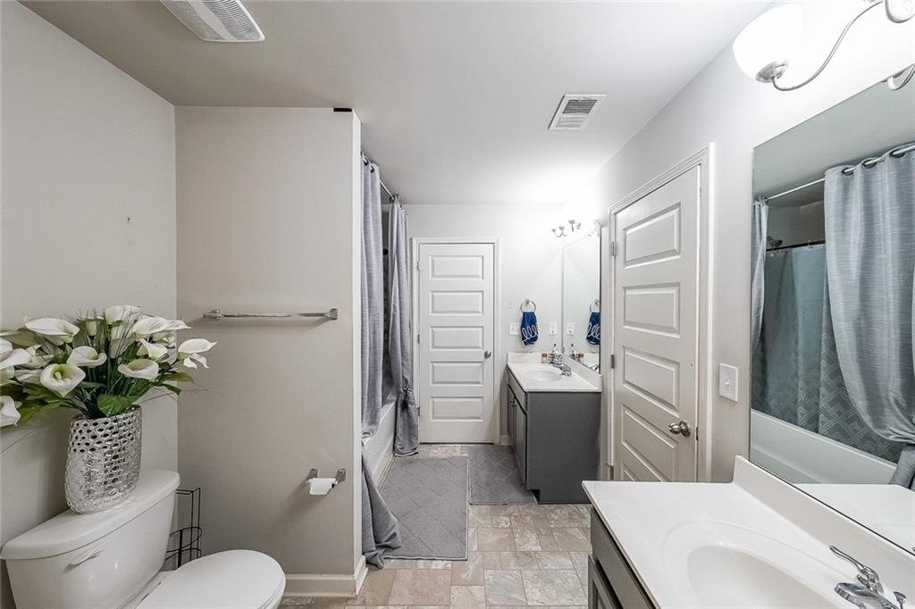 8097 White Oak Loop Lithonia, GA 30038 - Photo 22 of 25 a bathroom with a sink a toilet and shower