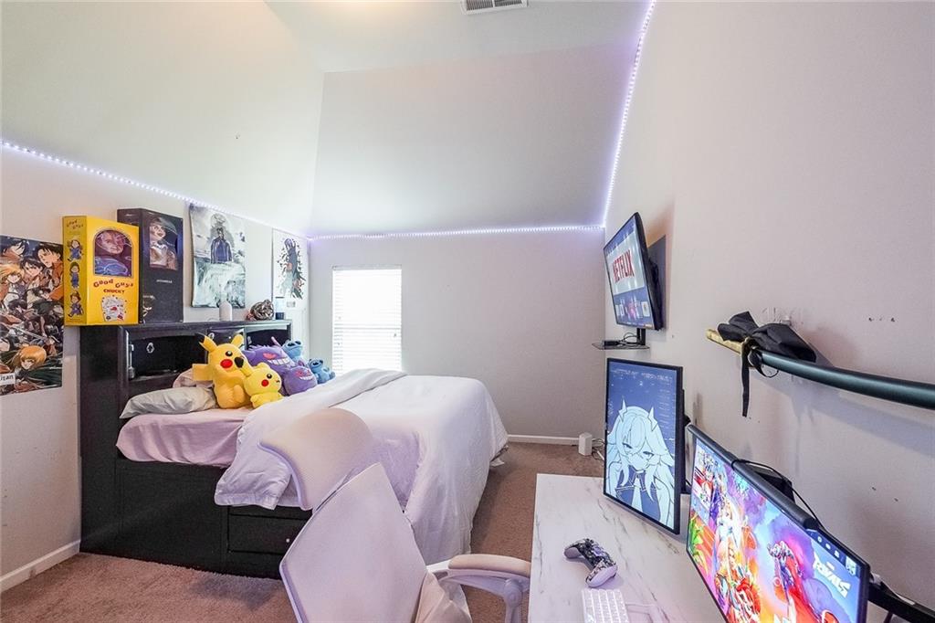 8097 White Oak Loop Lithonia, GA 30038 - Photo 24 of 25 a bedroom with bed and a couch