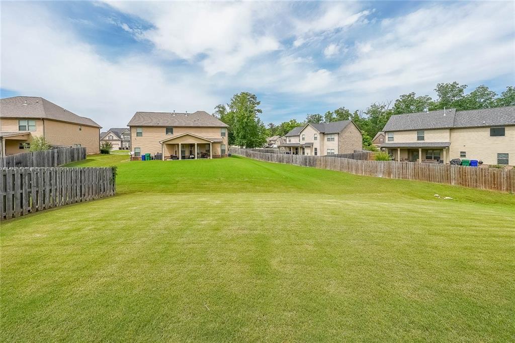 8097 White Oak Loop Lithonia, GA 30038 - Photo 4 of 25 a view of a house with a big yard and potted plants