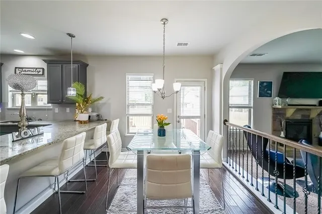 a living room with furniture a flat screen tv and a chandelier