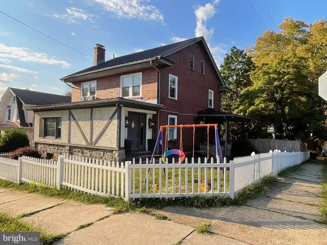 a front view of a house with a fence