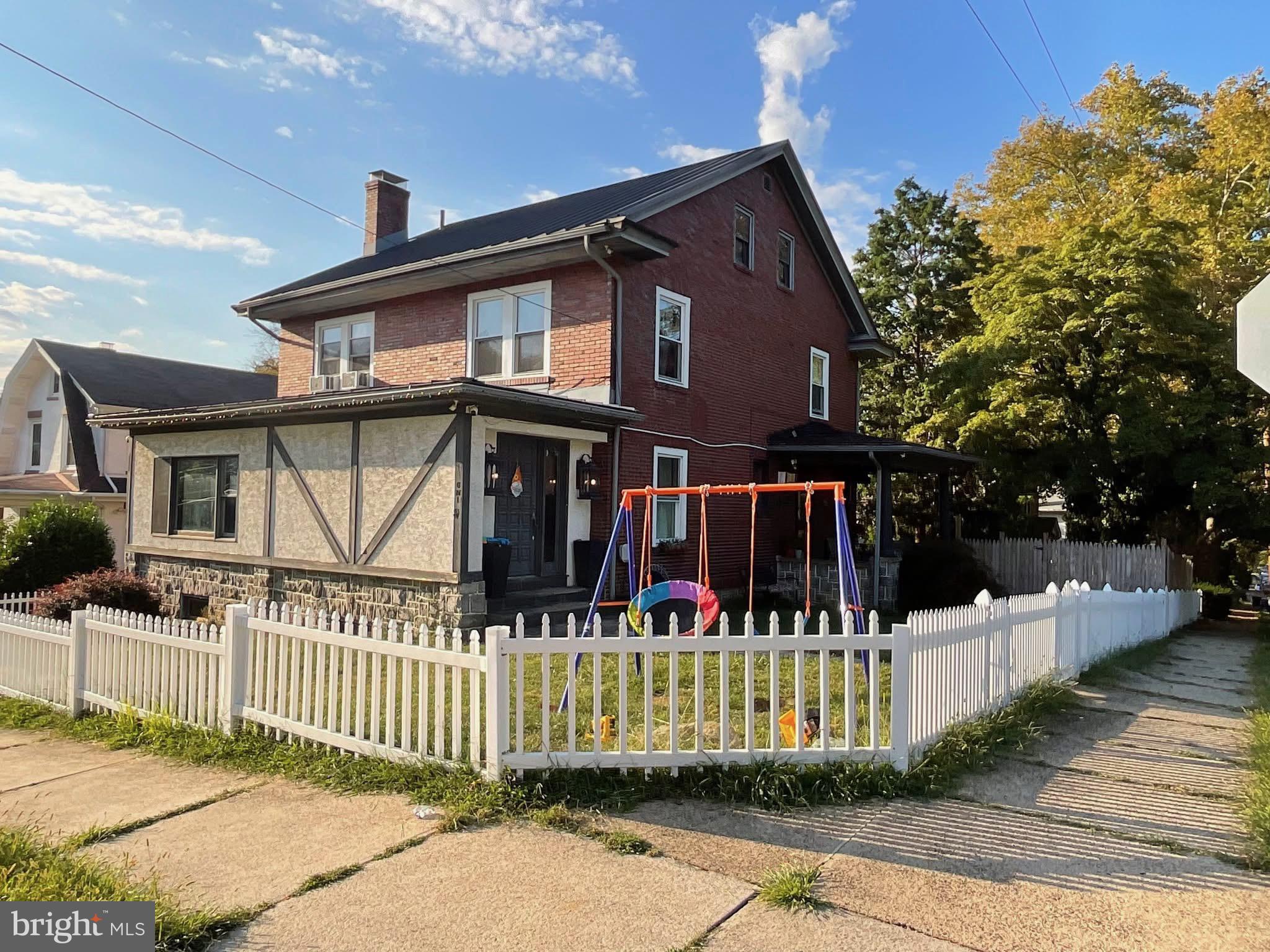 a front view of a house with a fence