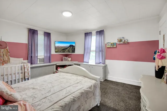 a bedroom with a bed and a dresser