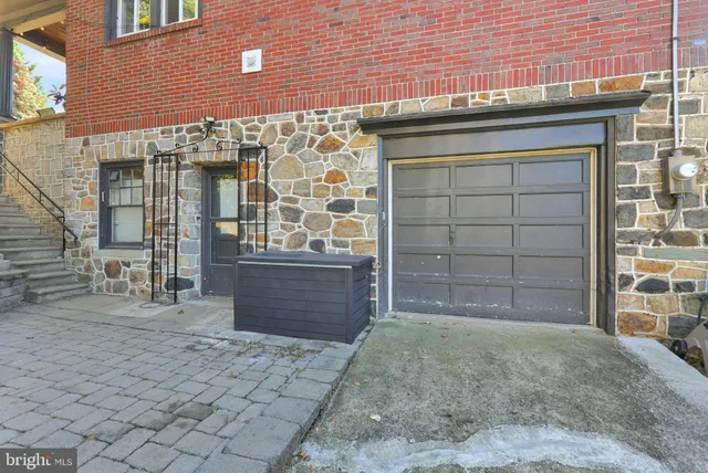 a front view of a house with a large parking space