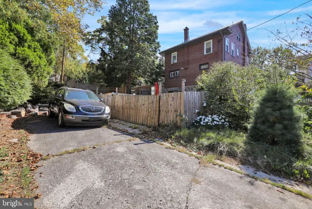 a car parked in front of a brick house
