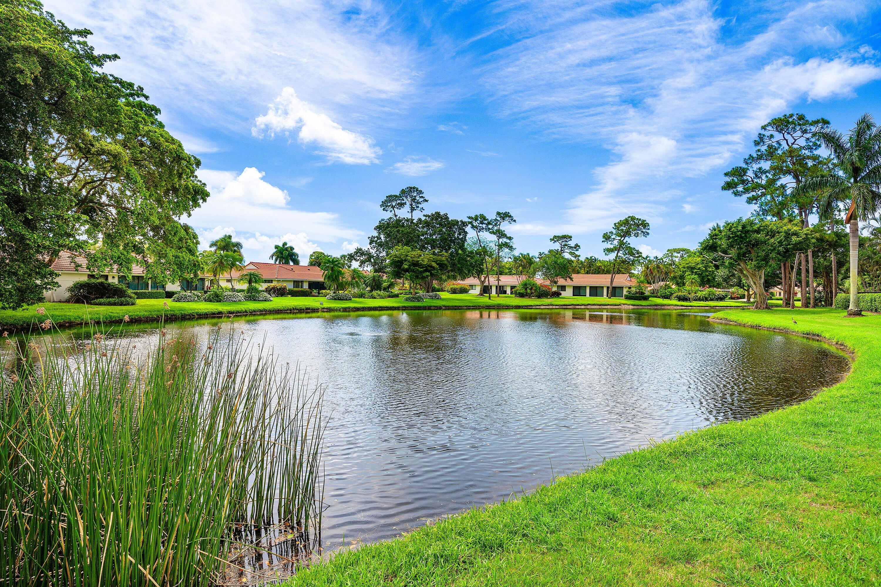 4365 Shell Drake Lane Boynton Beach, FL 33436 - Photo 30 of 56 a view of a lake with a house in the background