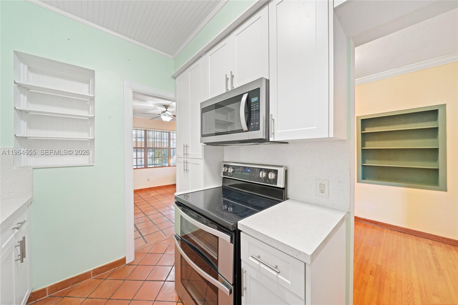7110 Southwest 13th Terrace Miami, FL 33144 - Photo 11 of 39 a kitchen with a stove and a microwave