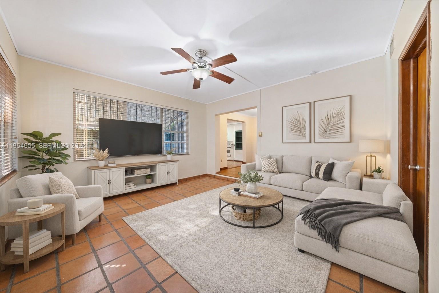 7110 Southwest 13th Terrace Miami, FL 33144 - Photo 13 of 39 a living room with furniture and a flat screen tv