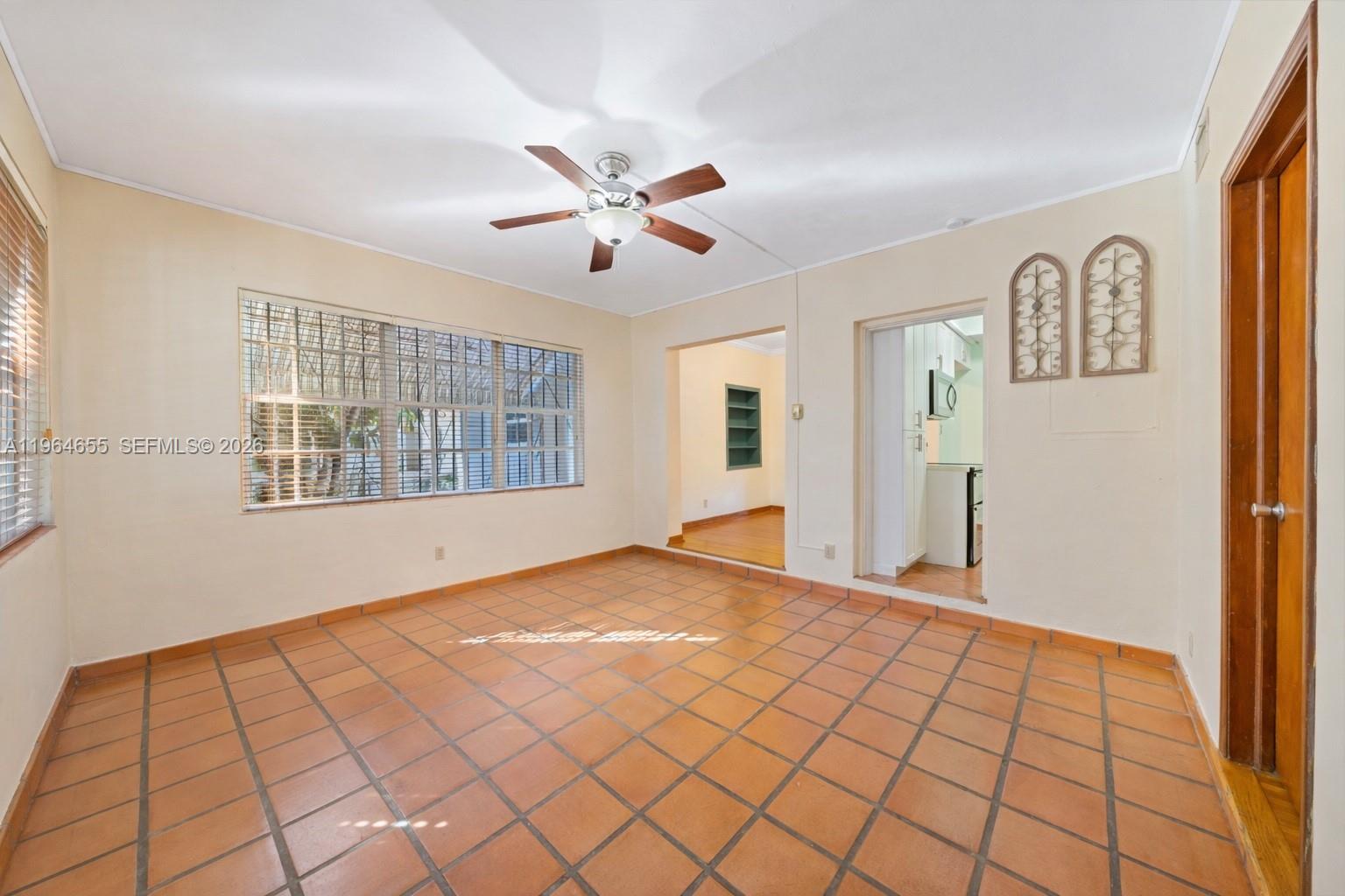 7110 Southwest 13th Terrace Miami, FL 33144 - Photo 14 of 39 a view of an empty room with window and cabinet