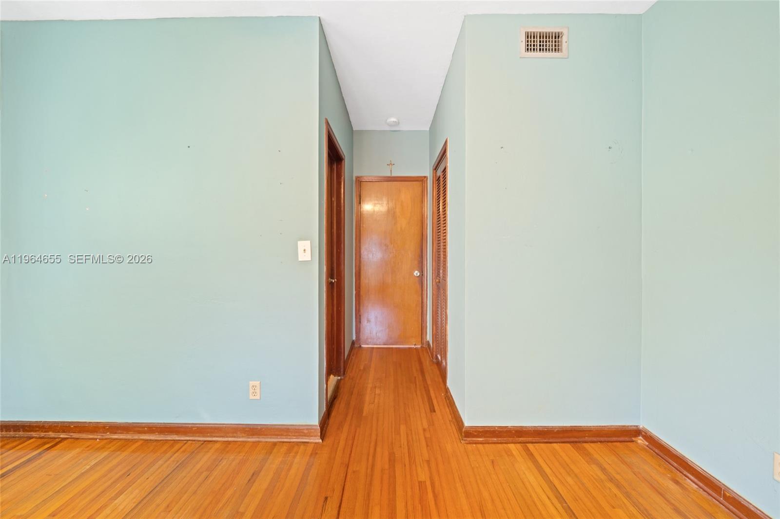 7110 Southwest 13th Terrace Miami, FL 33144 - Photo 18 of 39 a view of a room with wooden floor and door