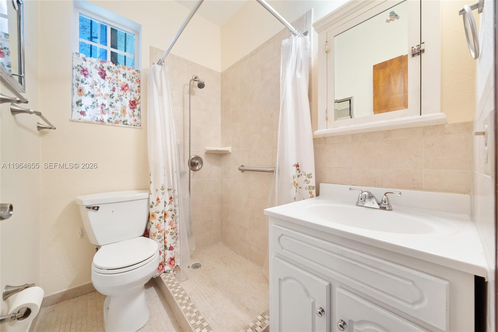 7110 Southwest 13th Terrace Miami, FL 33144 - Photo 22 of 39 a bathroom with a sink mirror vanity and toilet