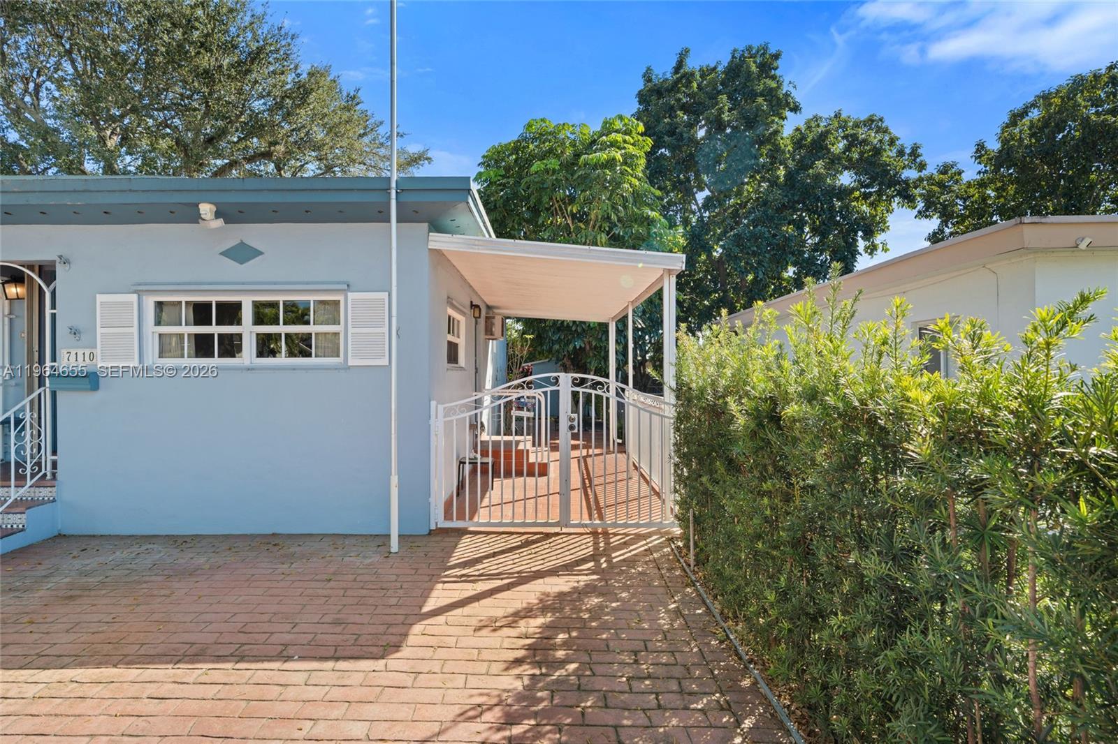 7110 Southwest 13th Terrace Miami, FL 33144 - Photo 24 of 39 a view of a patio with a table and chairs and potted plants