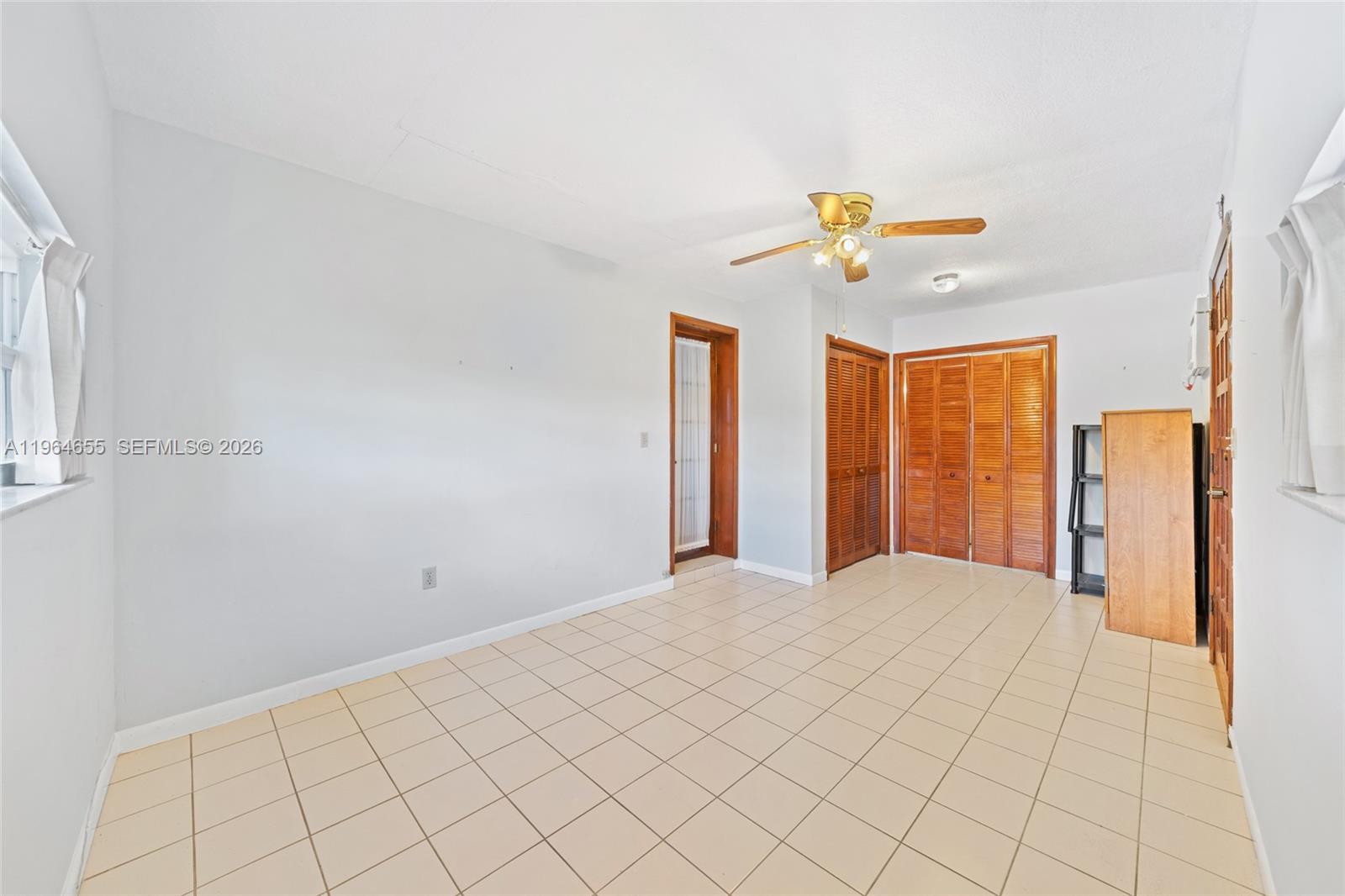 7110 Southwest 13th Terrace Miami, FL 33144 - Photo 27 of 39 a view of a livingroom with a chandelier fan and window