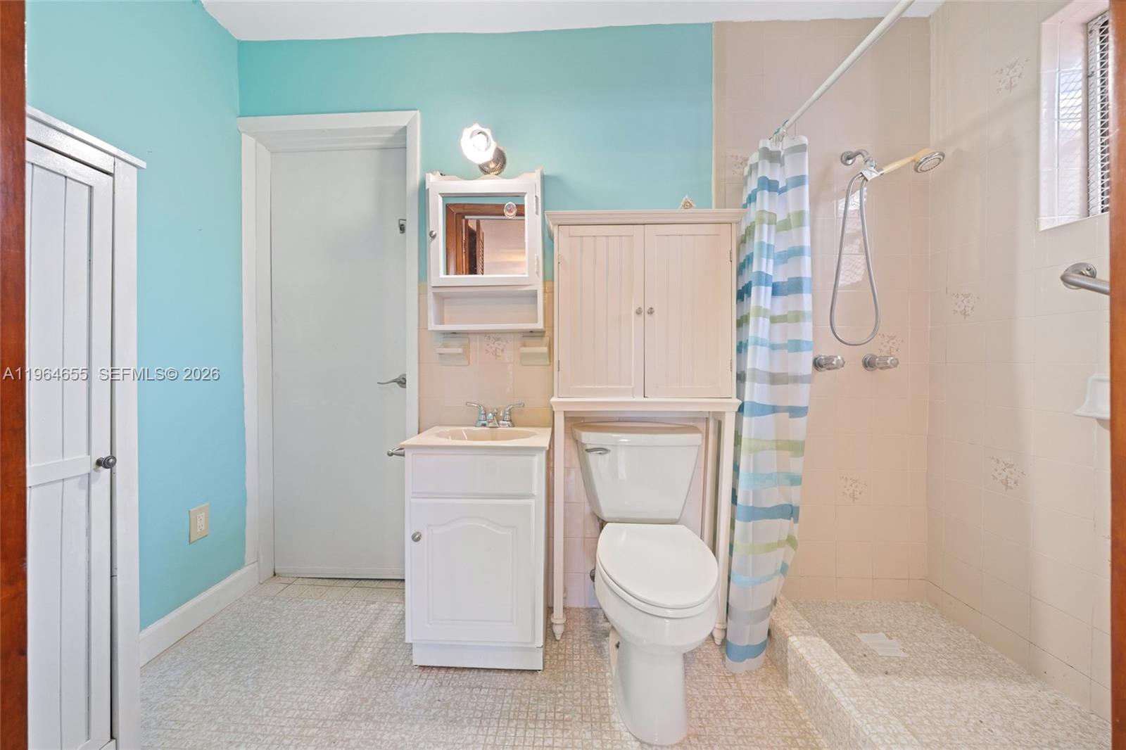 7110 Southwest 13th Terrace Miami, FL 33144 - Photo 29 of 39 a bathroom with a toilet and a shower