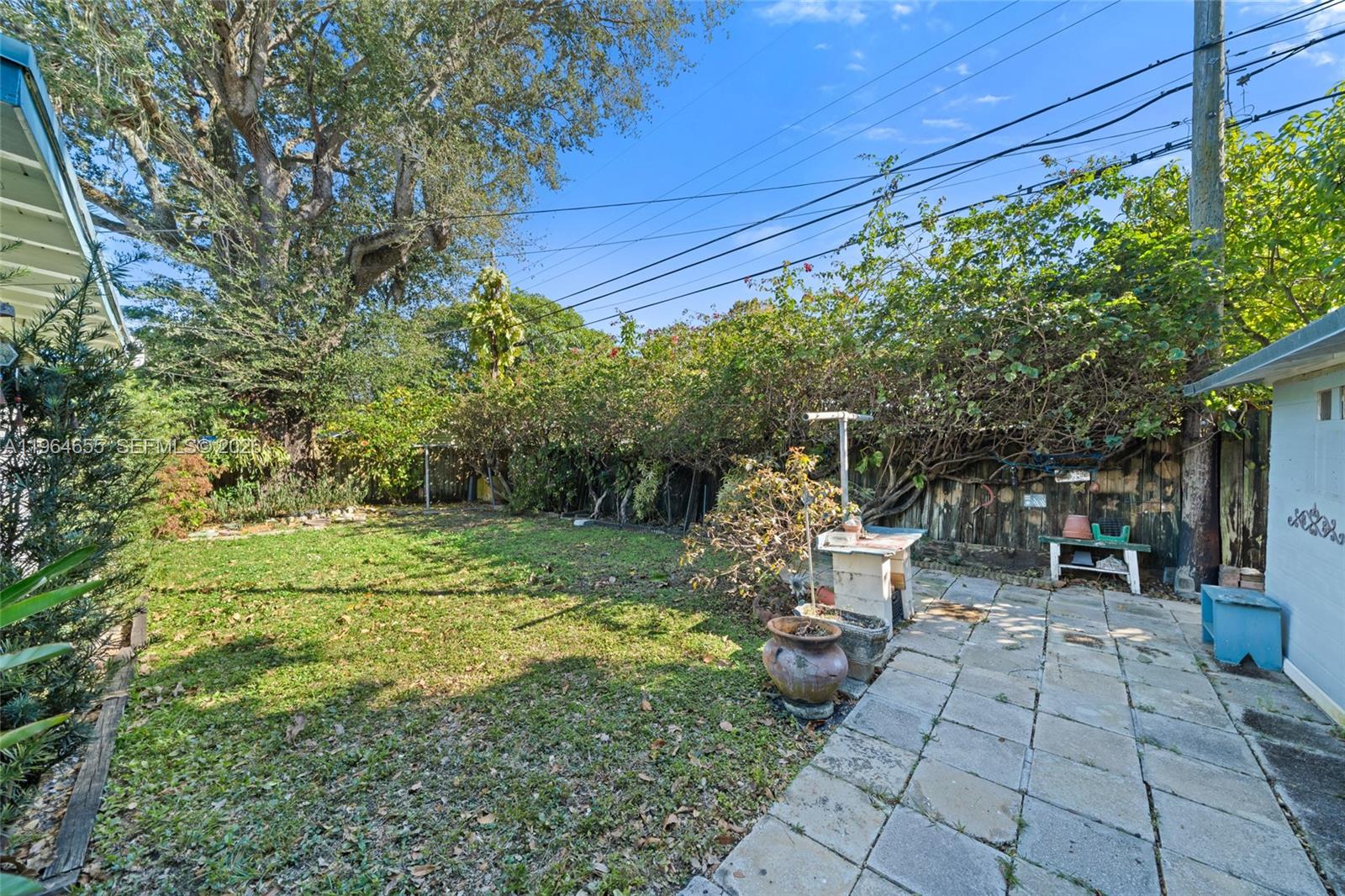 7110 Southwest 13th Terrace Miami, FL 33144 - Photo 34 of 39 a view of backyard with table and chairs and potted plants