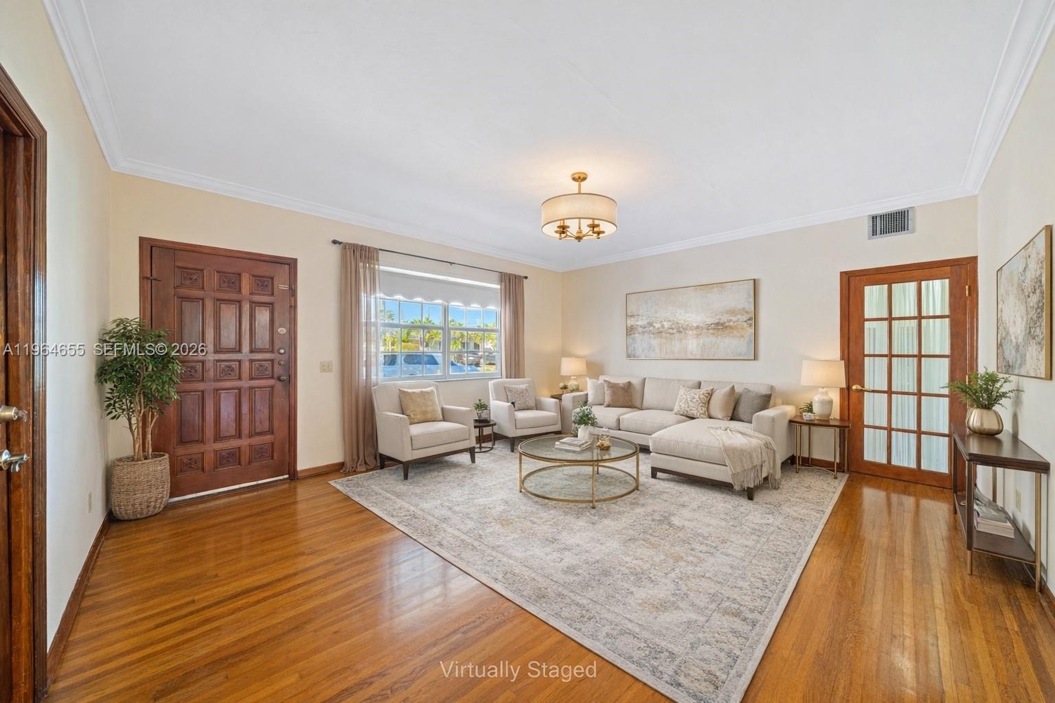 7110 Southwest 13th Terrace Miami, FL 33144 - Photo 4 of 39 a living room with furniture and wooden floor