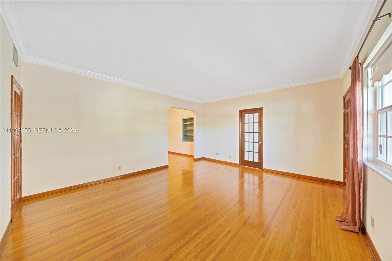 7110 Southwest 13th Terrace Miami, FL 33144 - Photo 7 of 39 an empty room with wooden floor and windows