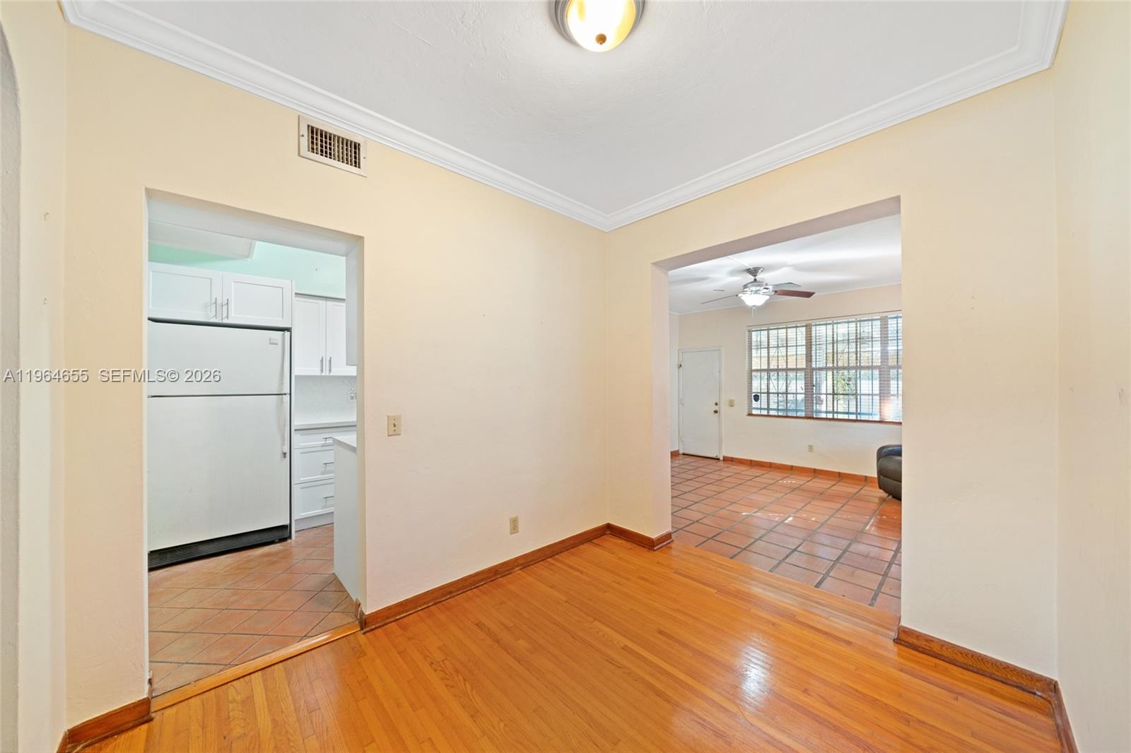 7110 Southwest 13th Terrace Miami, FL 33144 - Photo 8 of 39 a view of empty room with wooden floor and fan