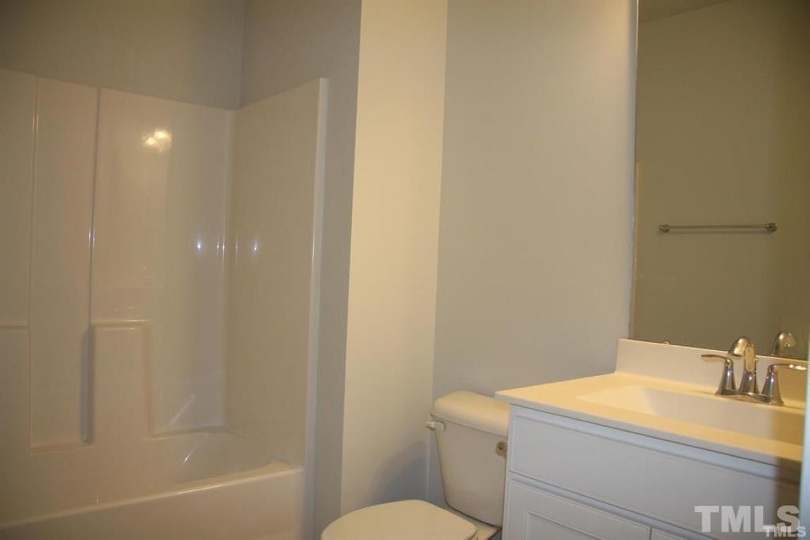 2919 Sunflower Road Apex, NC 27502 - Photo 8 of 34 a bathroom with a sink a toilet and shower