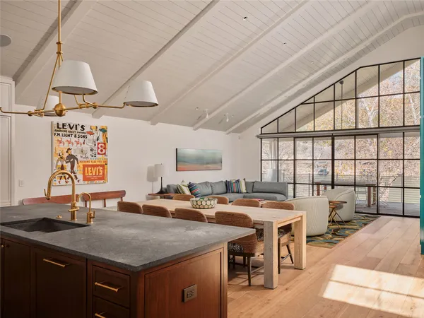 a kitchen with a table chairs stove and cabinets