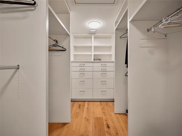 a view of walk in closet with empty racks