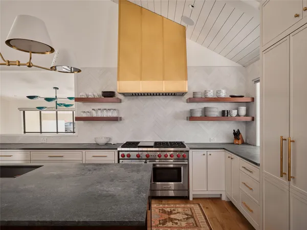 a kitchen with stainless steel appliances granite countertop a sink and a stove