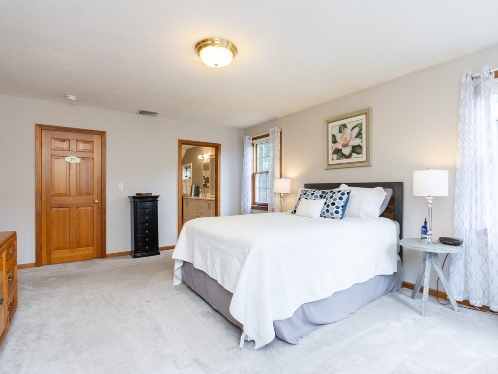 72 Emerson Road Walpole, MA 02032 - Photo 25 of 41 a spacious bedroom with a bed and a cabinets