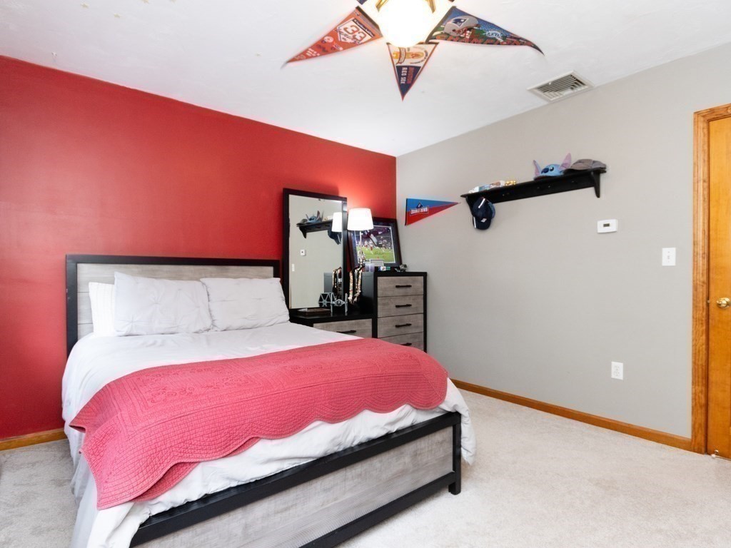 72 Emerson Road Walpole, MA 02032 - Photo 31 of 41 a bedroom with a bed and a mirror