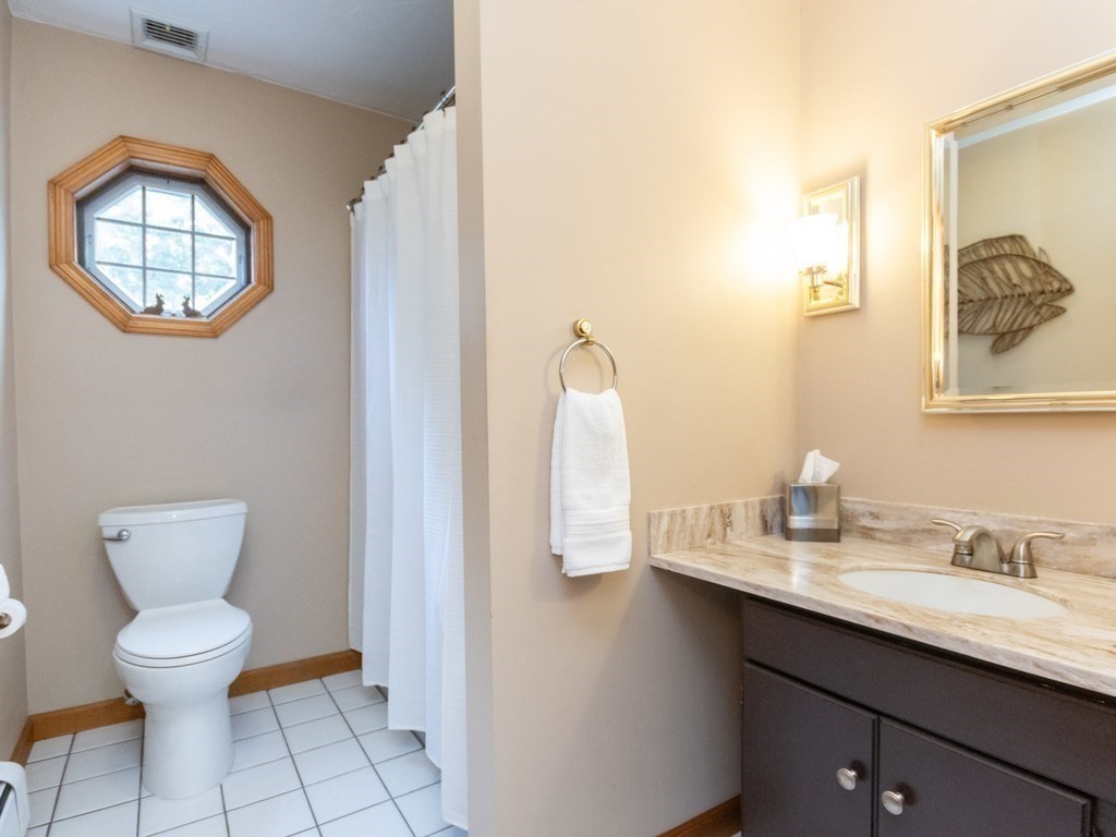 72 Emerson Road Walpole, MA 02032 - Photo 34 of 41 a bathroom with a toilet a sink and mirror