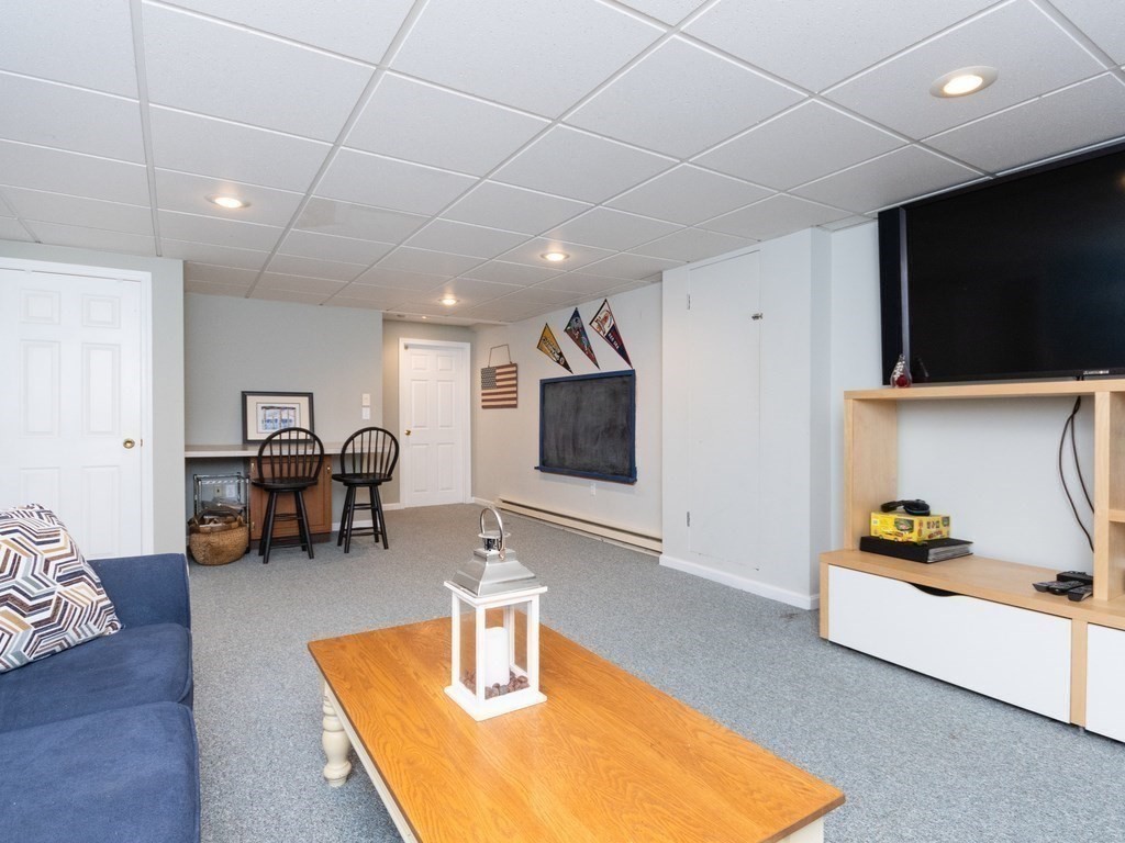 72 Emerson Road Walpole, MA 02032 - Photo 35 of 41 a living room with furniture and a flat screen tv