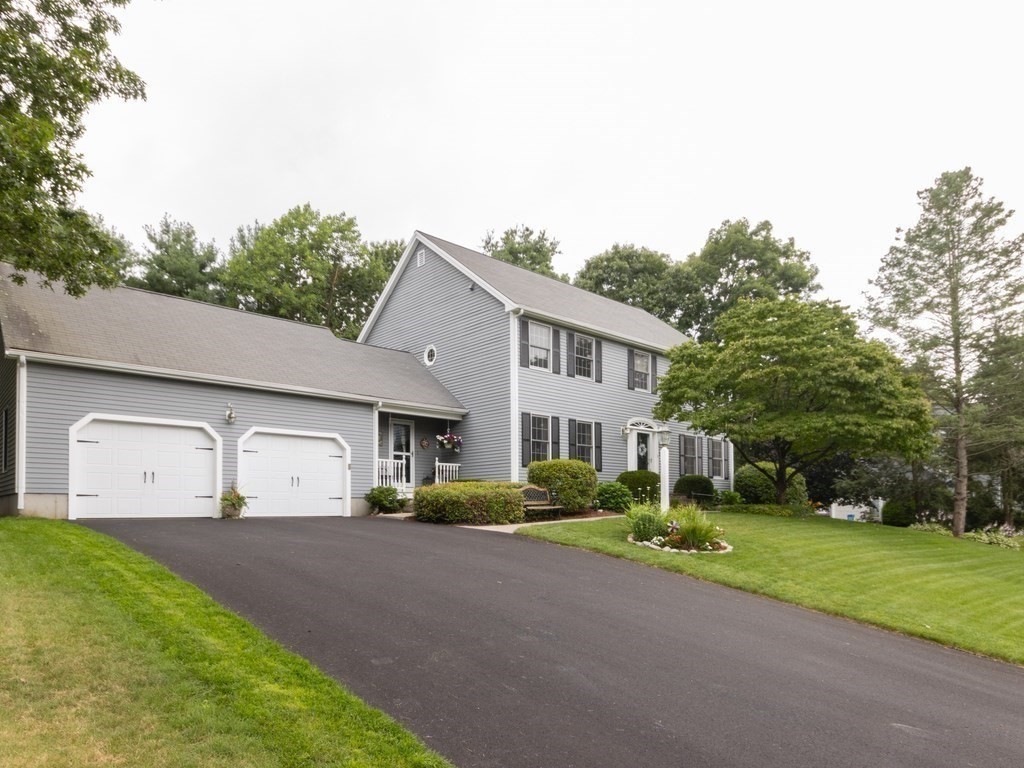 72 Emerson Road Walpole, MA 02032 - Photo 38 of 41 a view of a white house with a big yard and large trees