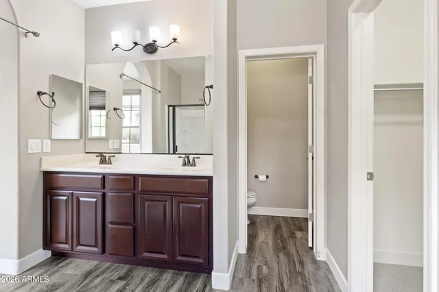 a bathroom with a sink a mirror and a shower