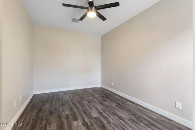 a view of a room with wooden floor and white walls