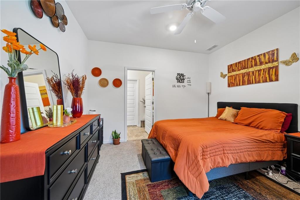 8592 Seabiscuit Road Lithonia, GA 30058 - Photo 10 of 25 a bedroom with a bed and a book shelf