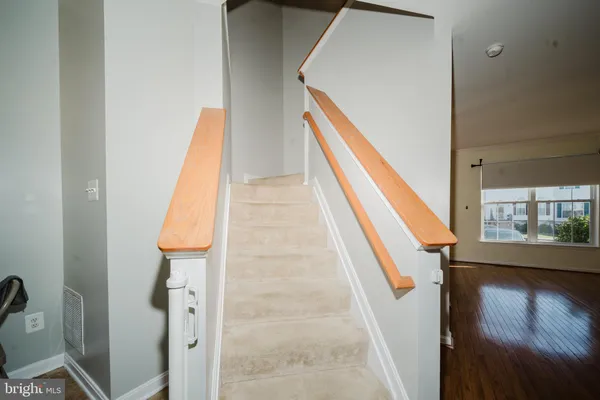 a view of a room with wooden floor and staircase