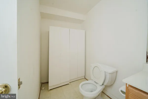 a white toilet sitting next to a bathroom sink