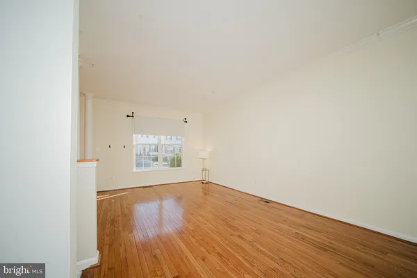 a view of an empty room and wooden floor